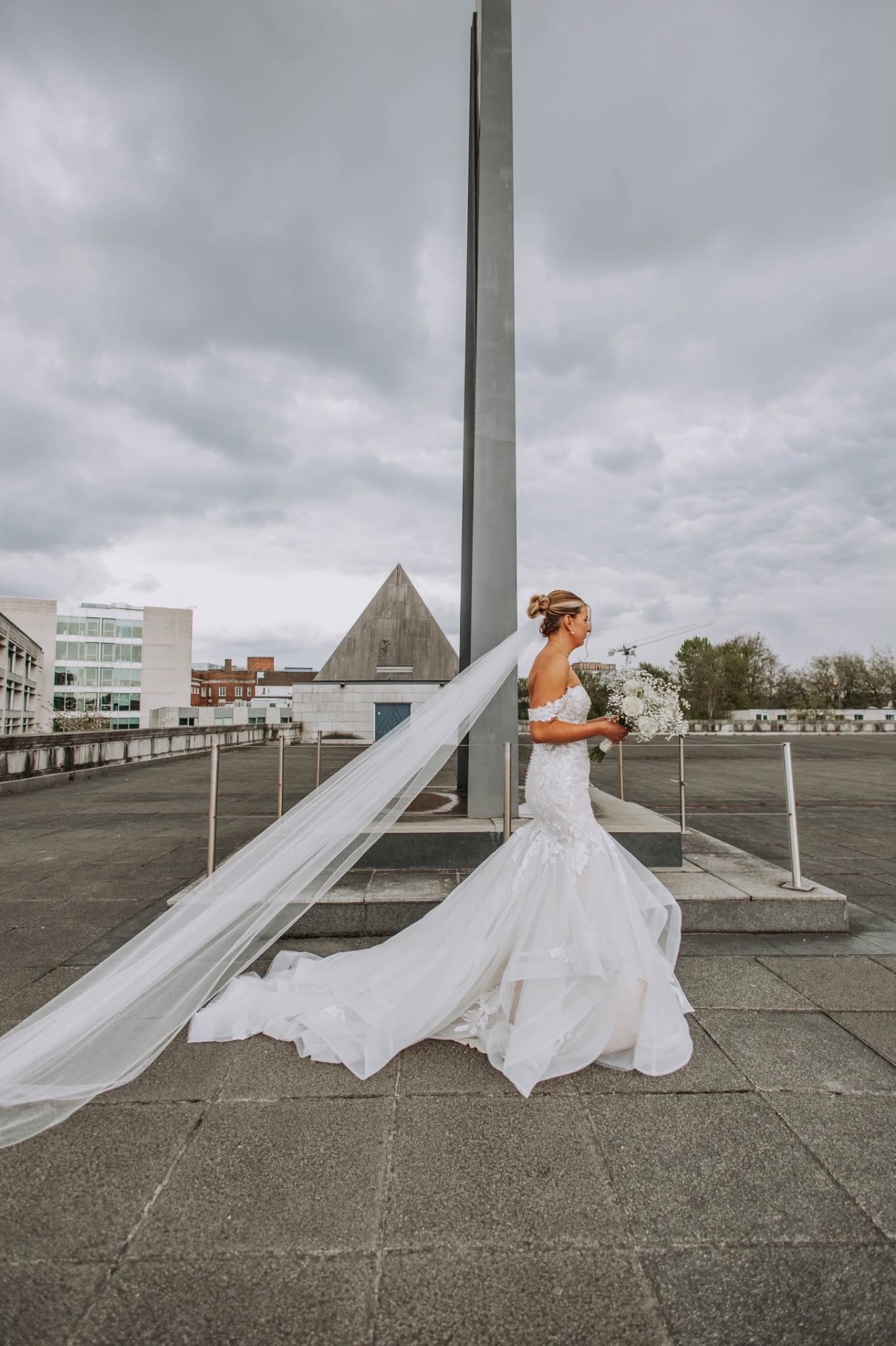 Bride with a cathedral veil catching the wind