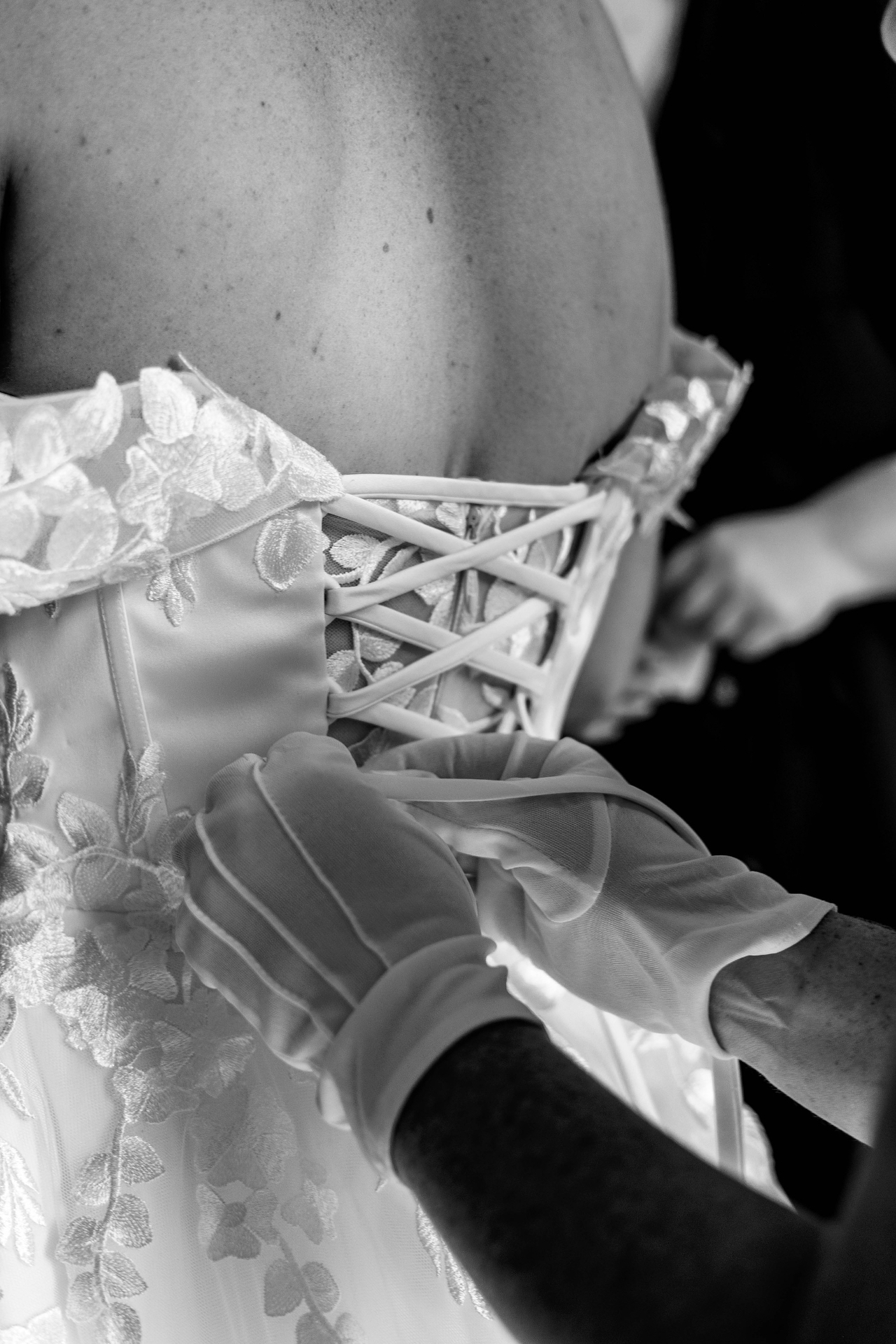 Dress being laced up before the ceremony