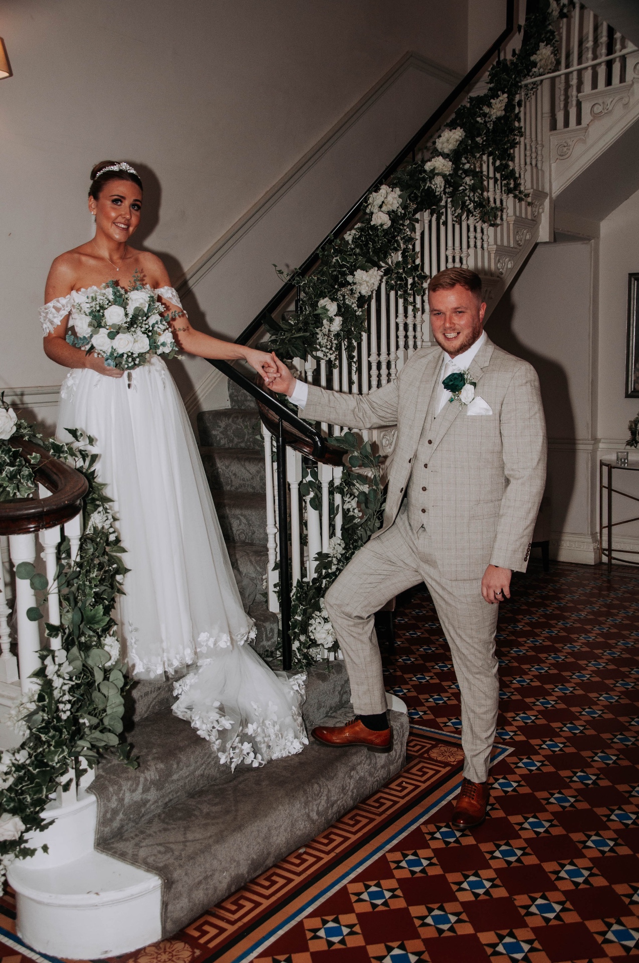 Bride and groom on a grand staircase
